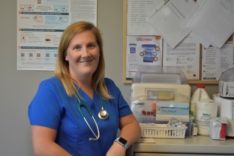 woman in scrubs smiling